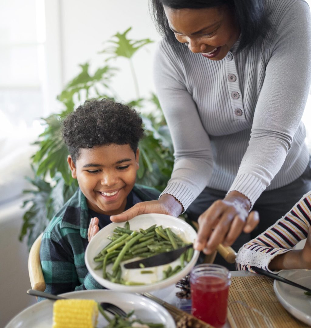 mother-putting-thanksgiving-day-food-her-son